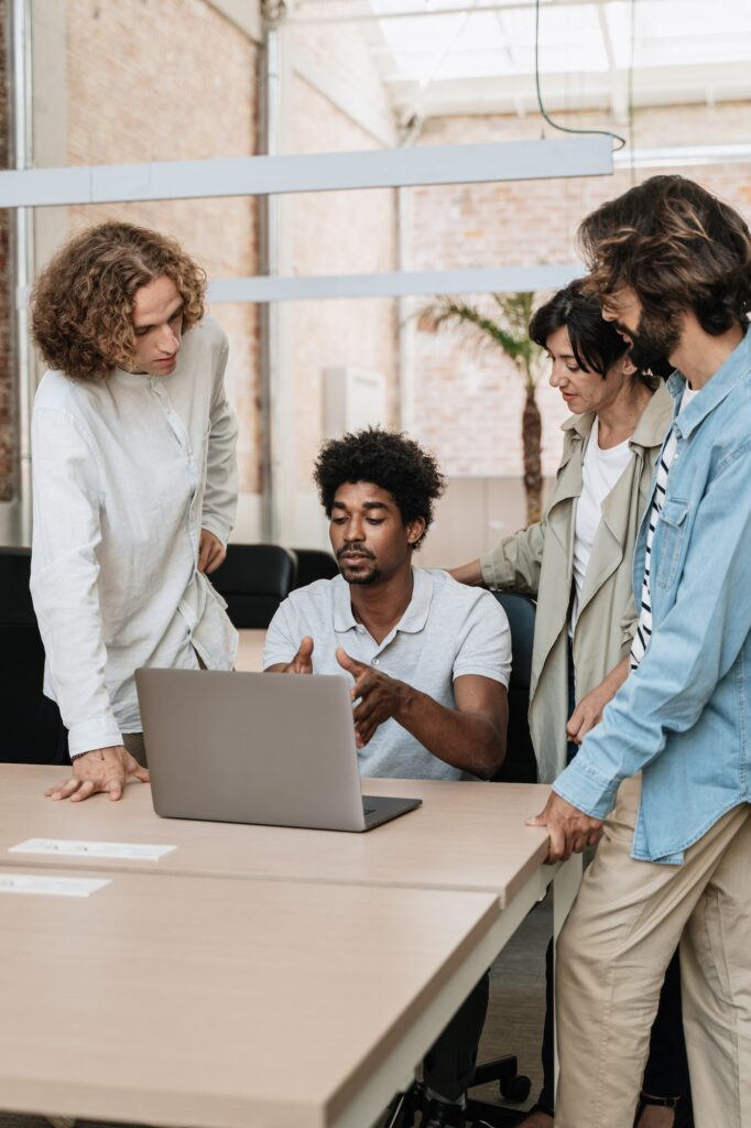 African American man explaining ideas and project to young team of diverse colleagues