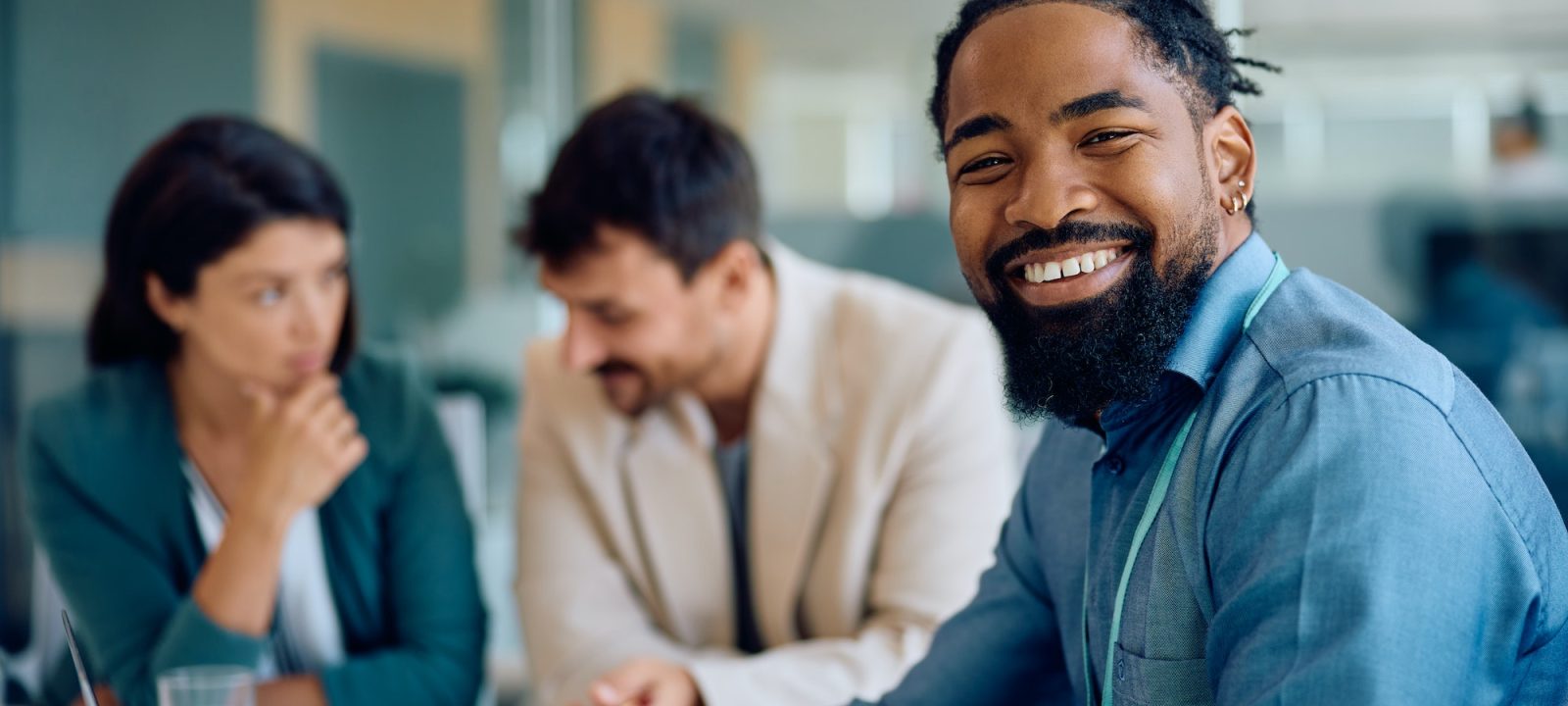 Happy black financial consultant on a meeting with his clients in the office.